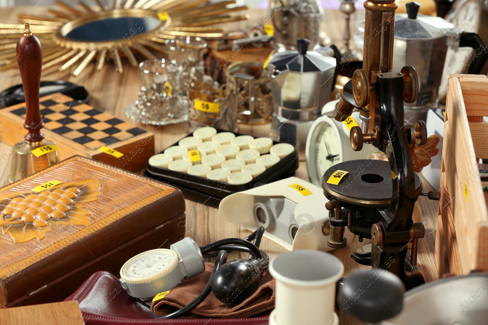 Photo of Many different items on wooden table. Garage sale