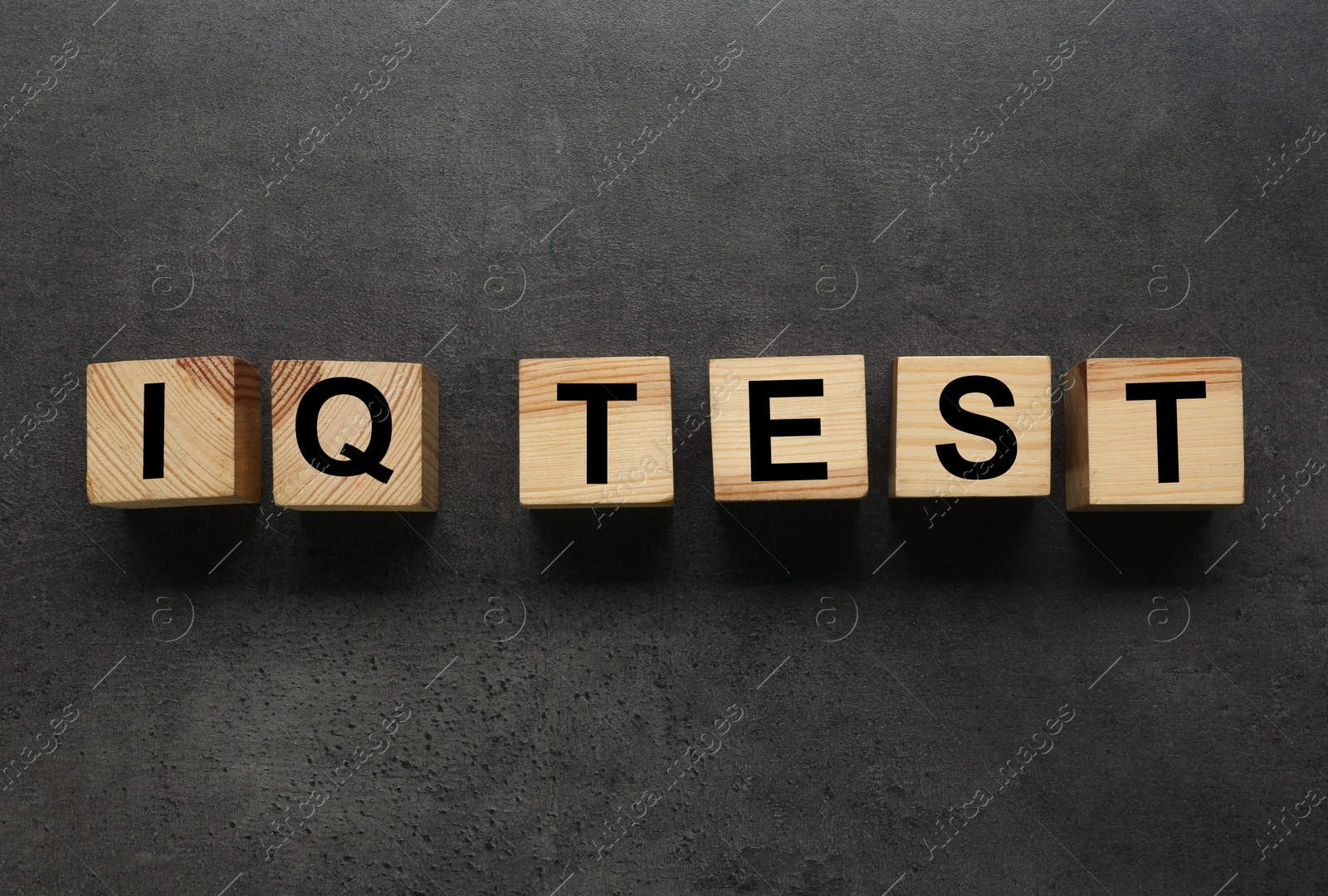 Photo of Cubes with text IQ Test on grey background, flat lay