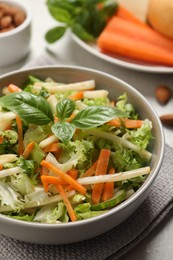 Photo of Delicious turnip salad served on light grey table, closeup