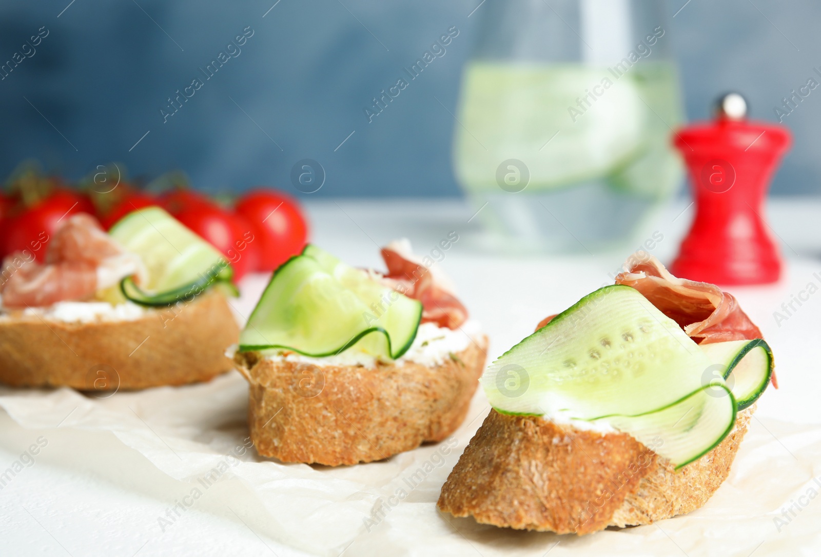 Photo of Tasty bruschettas with prosciutto served on table