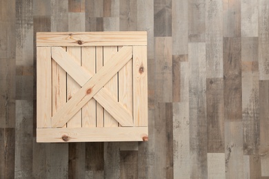 Photo of Wooden crate on floor, top view. Space for text