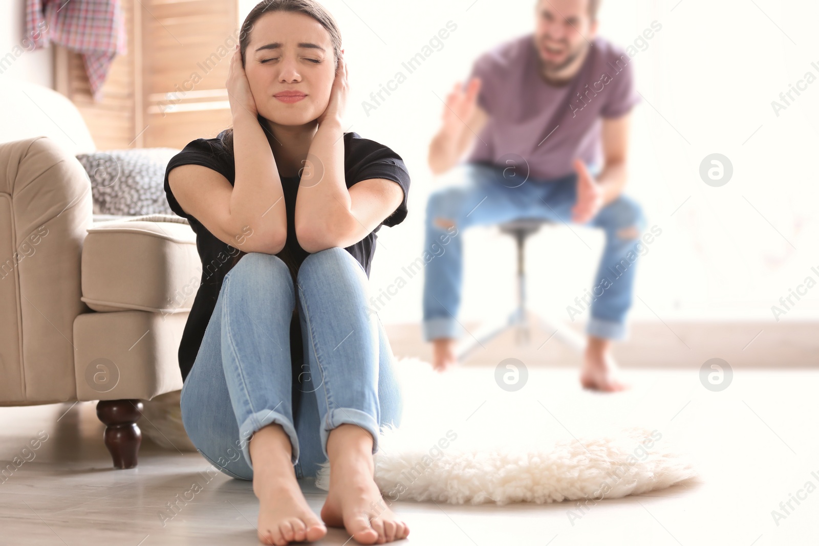 Photo of Young couple having argument in living room