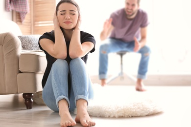 Young couple having argument in living room