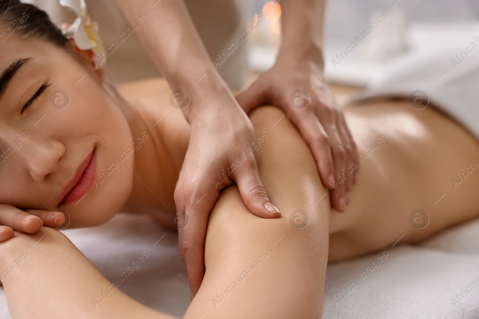 Photo of Woman receiving massage in spa salon, closeup