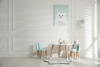 Photo of Baby room interior with stylish furniture and toys