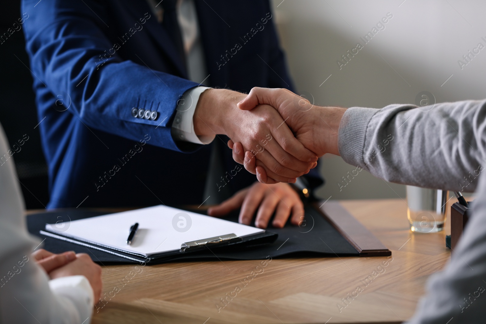 Photo of Male lawyer working with clients in office, closeup