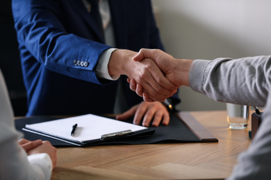 Male lawyer working with clients in office, closeup