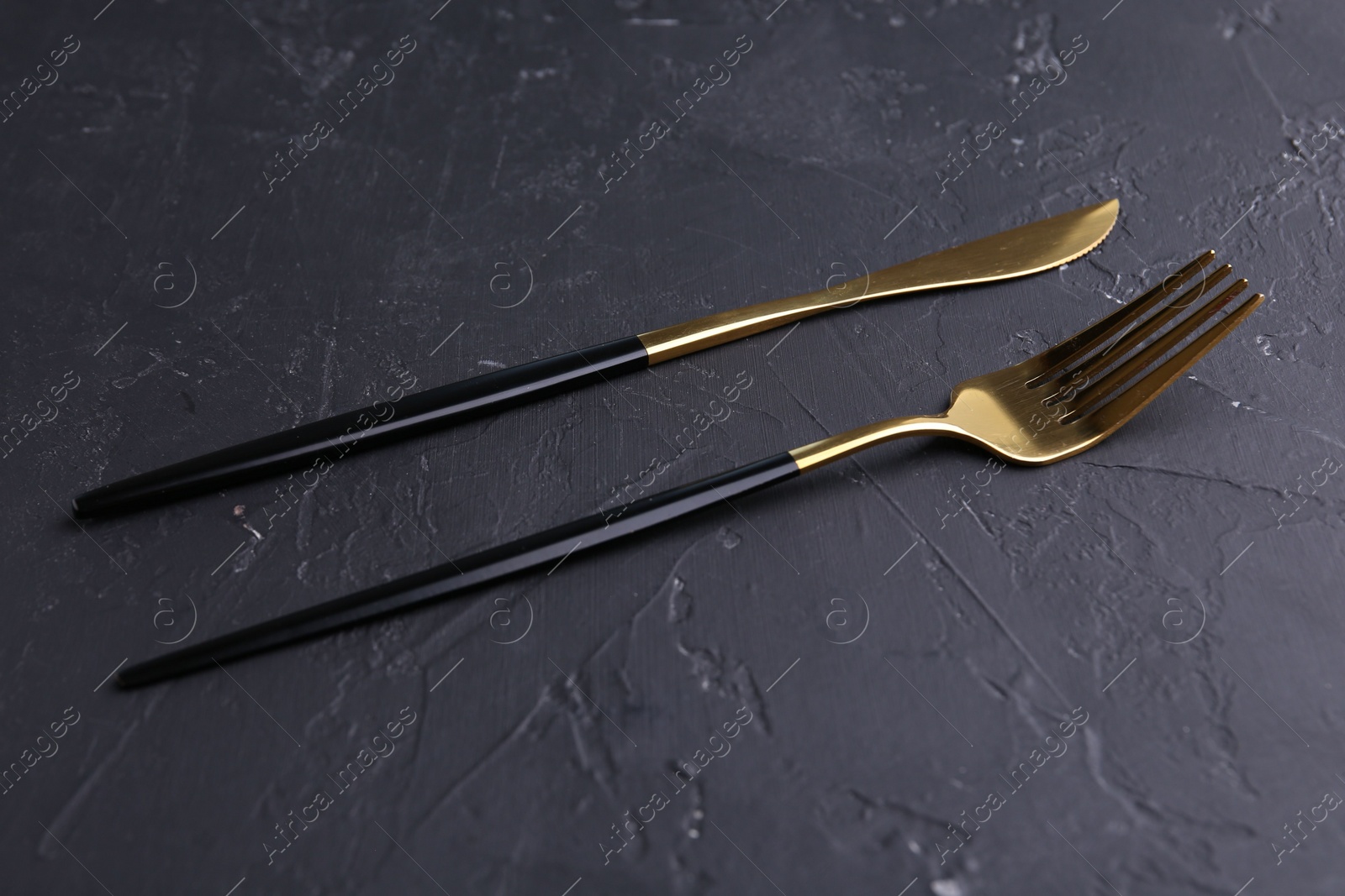 Photo of Set of beautiful cutlery on black table