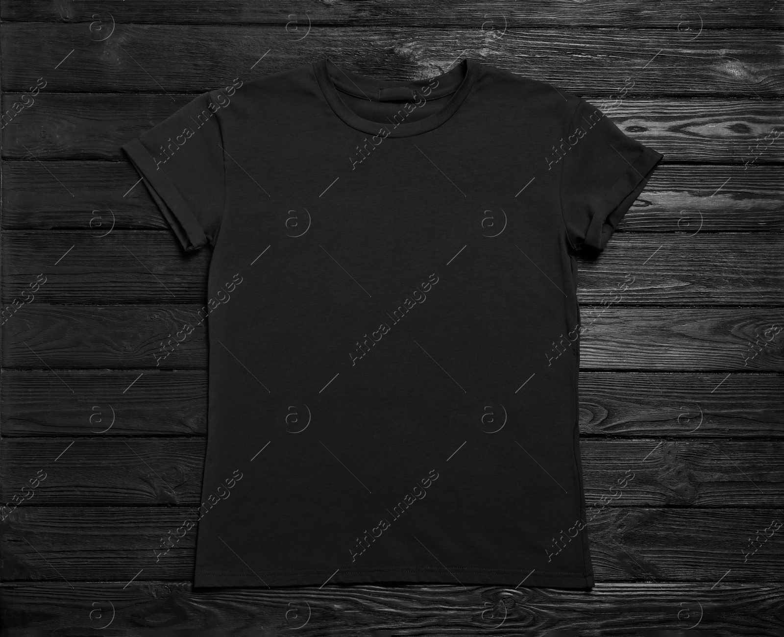 Photo of Stylish t-shirt on black wooden background, top view