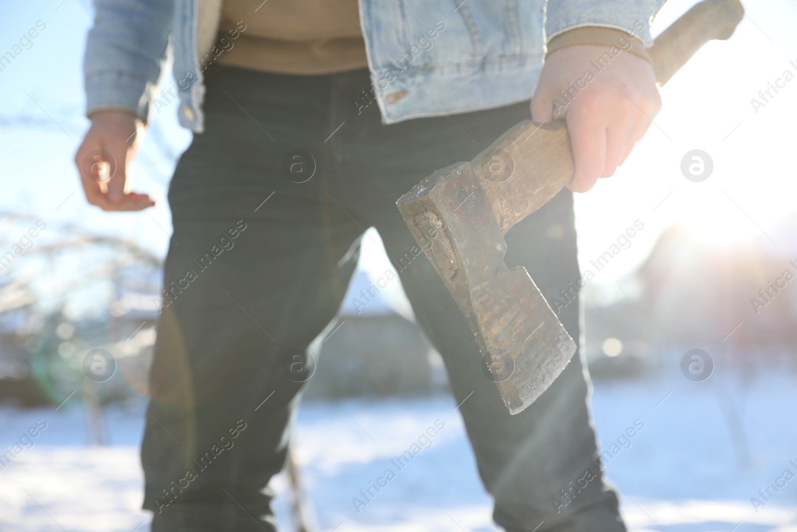 Photo of Man with axe outdoors on sunny winter day, closeup