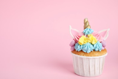 Photo of Cute sweet unicorn cupcake on pink background. Space for text