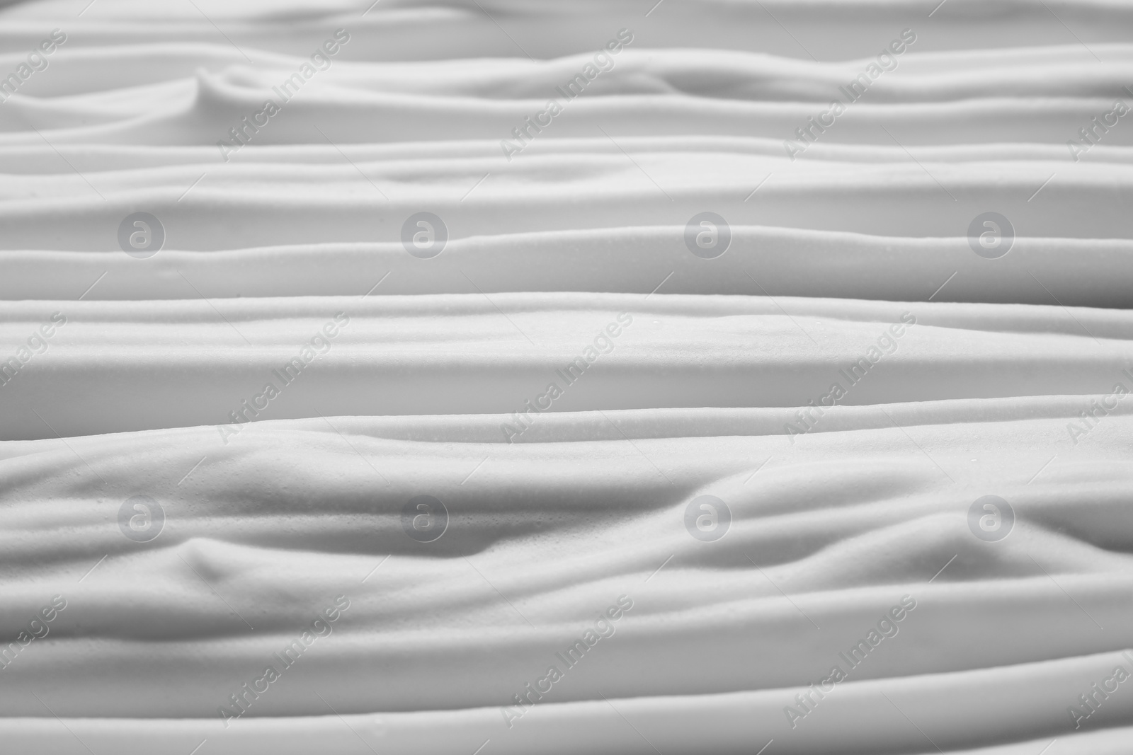 Photo of Texture of white shaving foam as background, top view