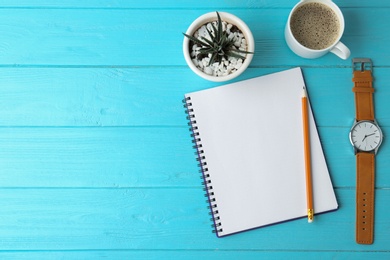 Photo of Flat lay composition with office stationery and cup of coffee on light blue wooden table. Space for text