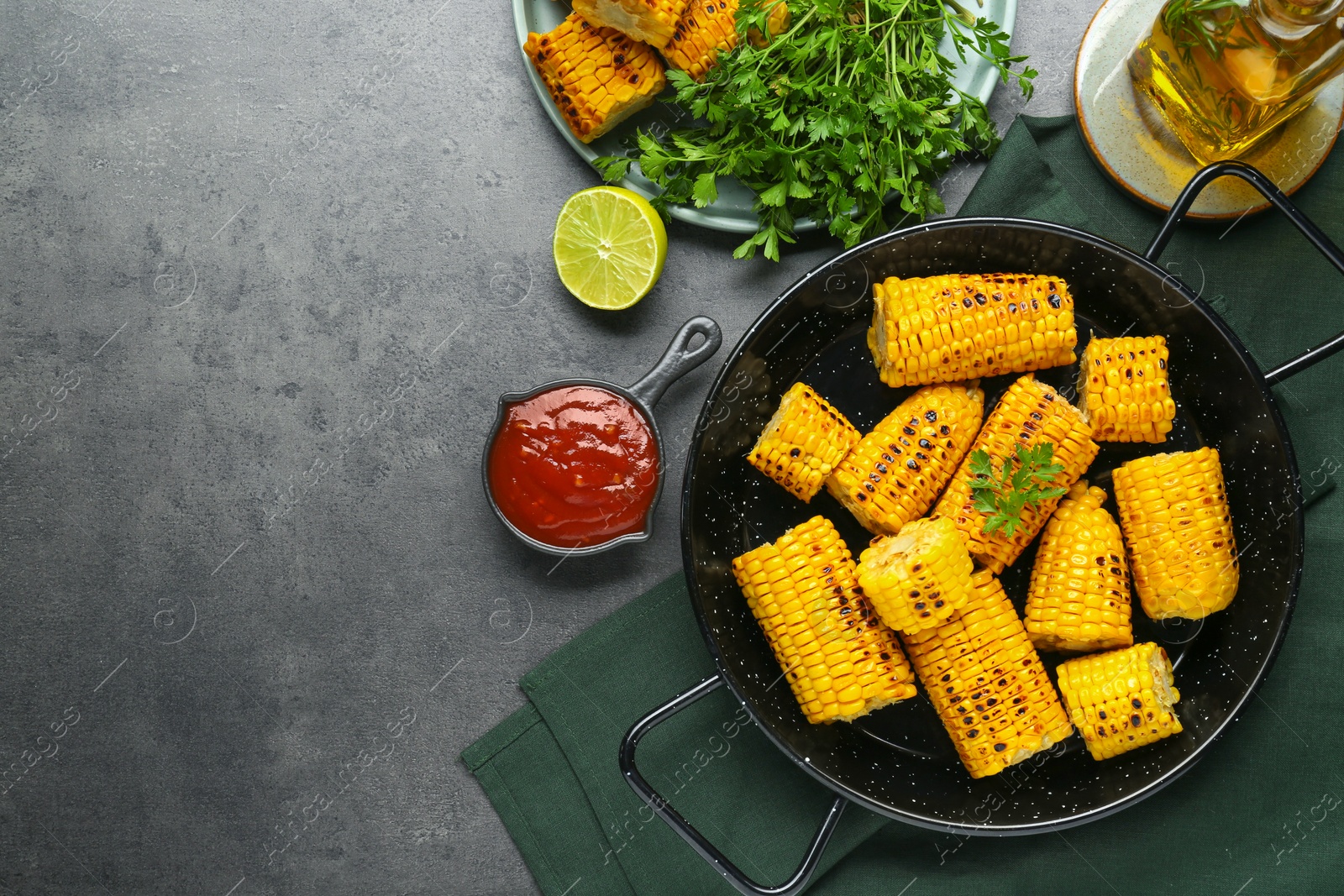 Photo of Flat lay composition with tasty corn and ingredients on dark grey table. Space for text