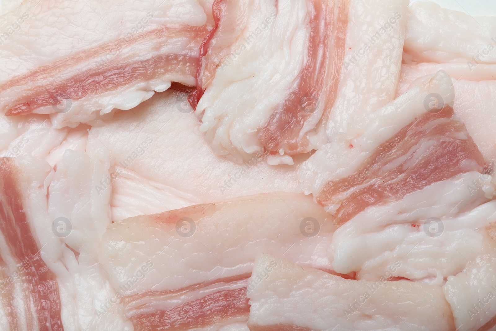 Photo of Slices of tasty salt pork as background, top view