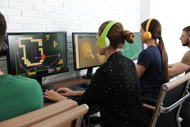 Young people playing video games on computers indoors. Esports tournament