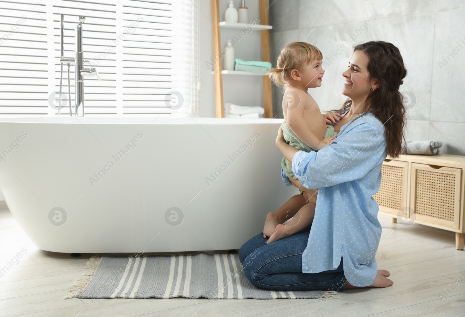 Photo of Mother with her daughter after bath at home