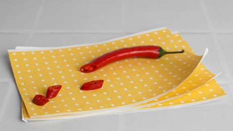 Pepper plaster and chili on white tiled table, closeup