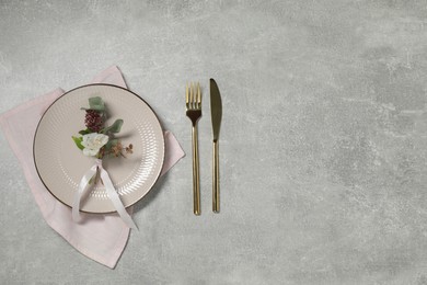 Photo of Stylish setting with elegant cutlery on grey table, flat lay. Space for text