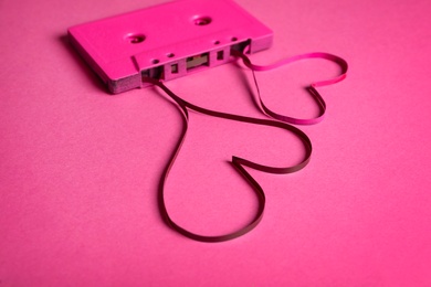 Photo of Music cassette and hearts made with tape on pink background. Listening love song