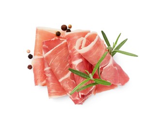 Photo of Slices of delicious jamon, spices and rosemary isolated on white, top view