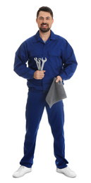 Full length portrait of professional auto mechanic with wrenches and rag on white background