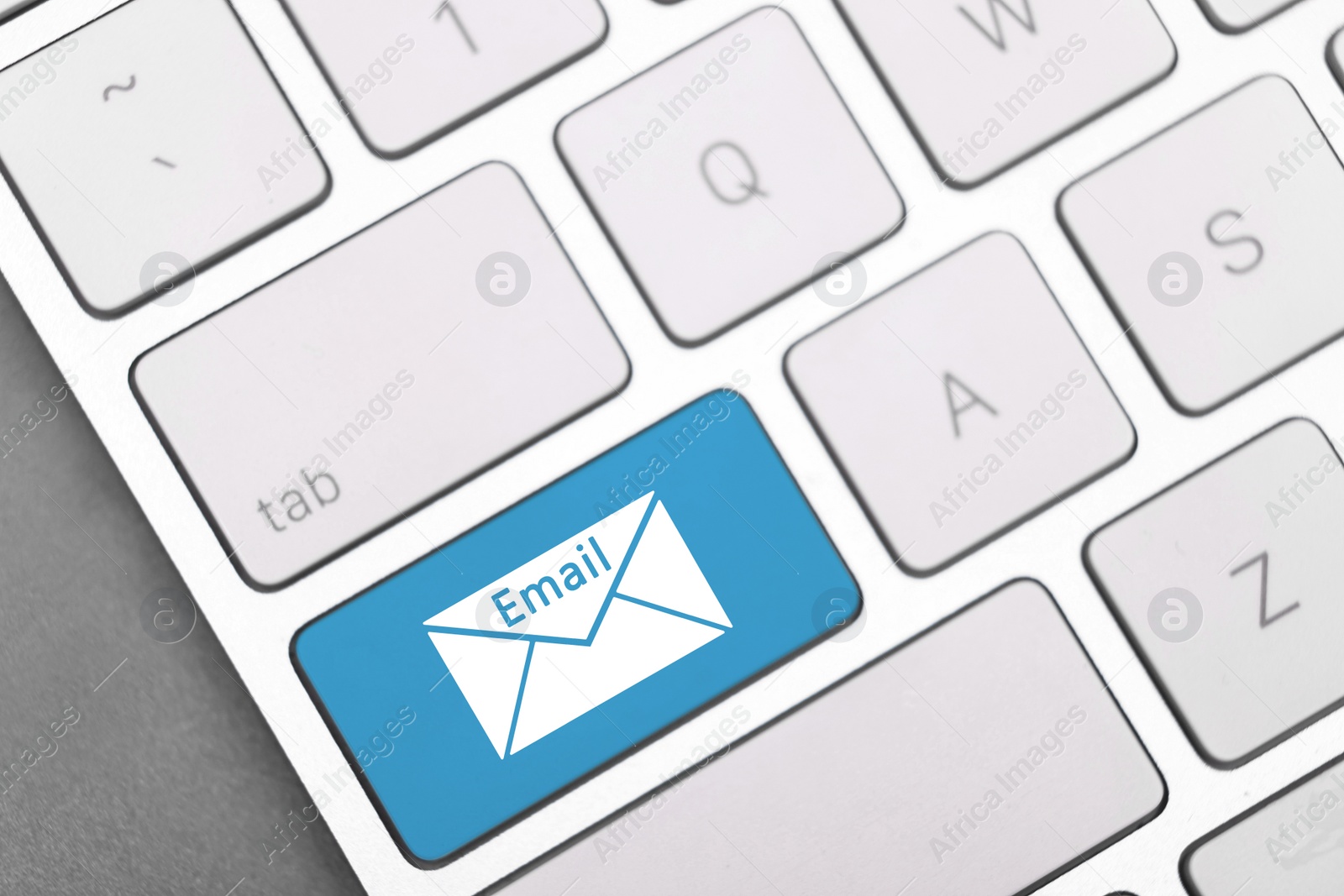 Image of Light blue button with word Email and illustration of envelope on keyboard, top view