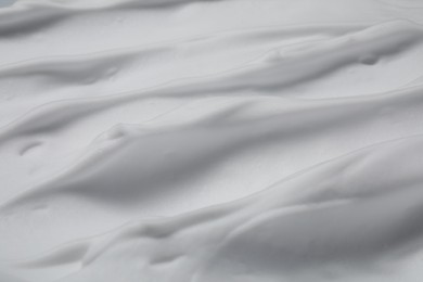 Photo of Texture of white shaving foam as background, top view