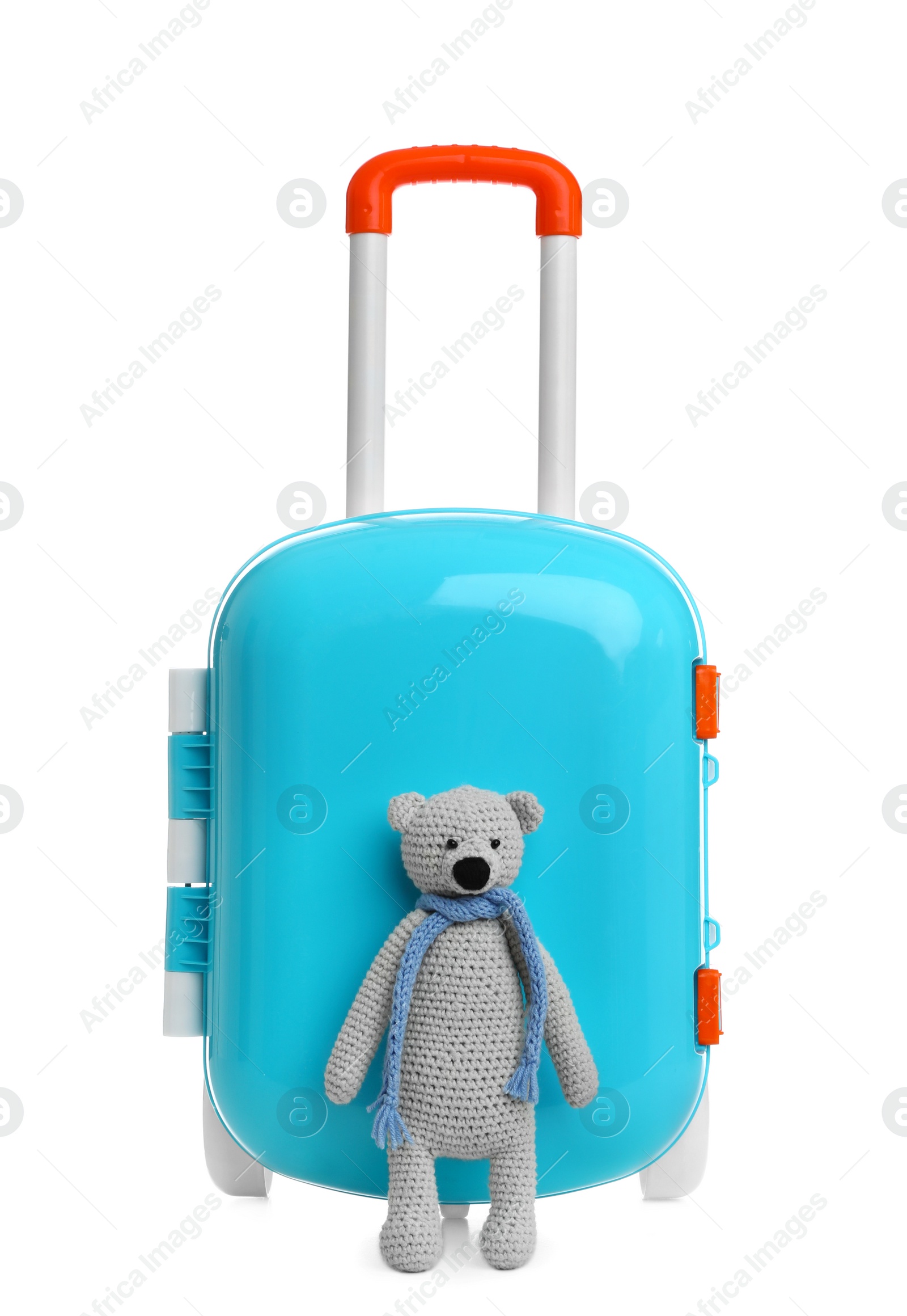 Photo of Stylish little blue suitcase with teddy bear on white background