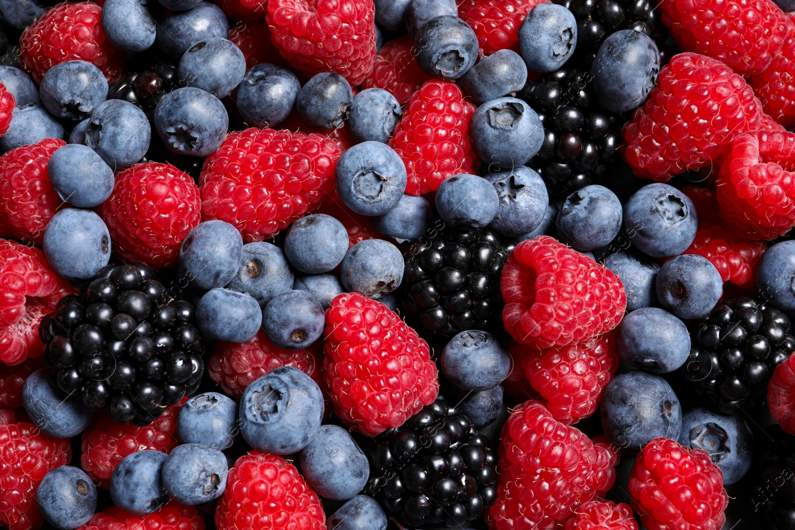 Photo of Assortment of fresh ripe berries as background, top view