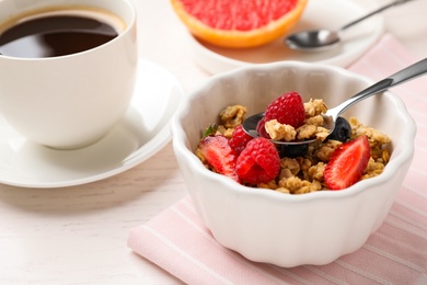 Photo of Tasty breakfast with muesli served on white wooden table
