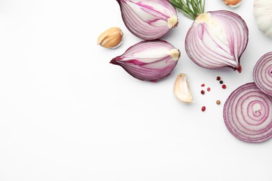 Photo of Fresh red onions, garlic, rosemary and spices on white background, flat lay. Space for text