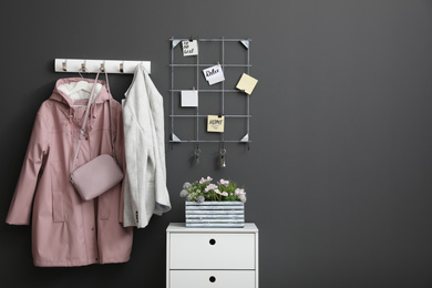 Photo of Hallway interior with stylish furniture, clothes and accessories
