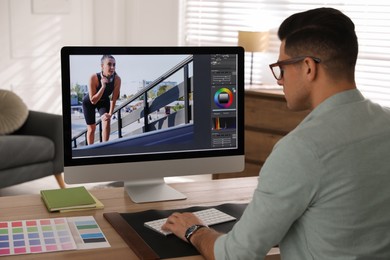 Professional retoucher working on computer in office