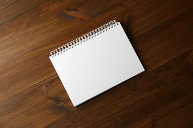 Blank paper brochure on wooden table, top view. Mockup for design