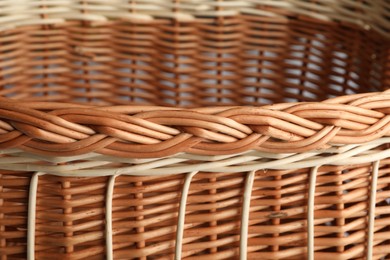 Photo of Handmade wicker basket made of natural material, closeup view