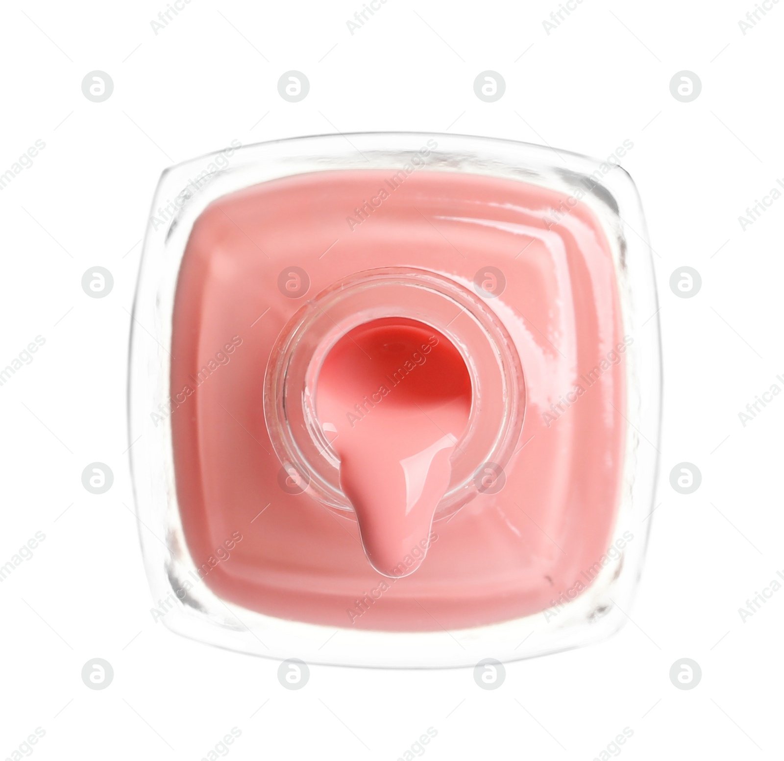 Photo of Pouring color nail polish from bottle on white background