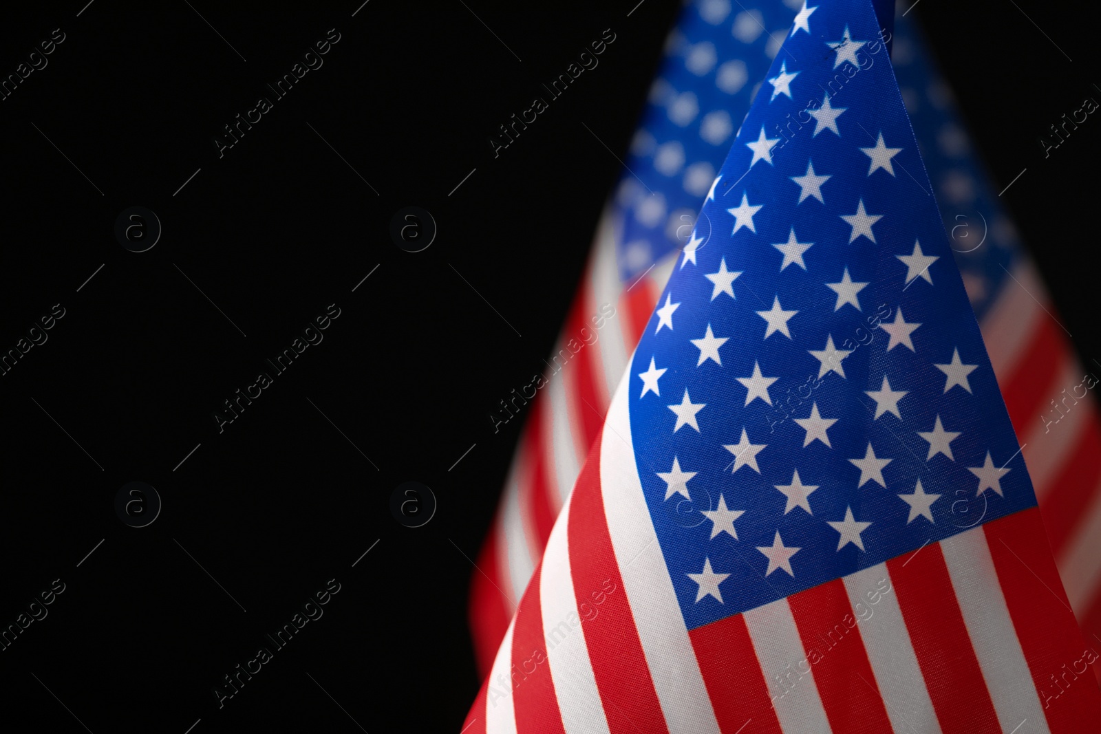 Photo of American flag on black background, closeup with space for text. Memorial Day