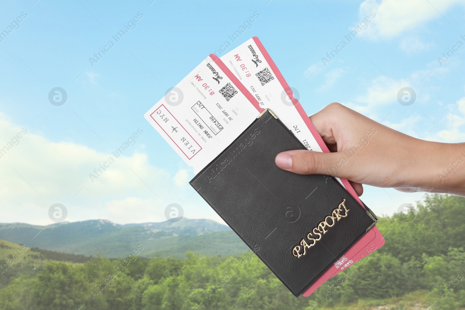 Image of Woman holding passport with tickets in mountains, closeup. Travel agency service