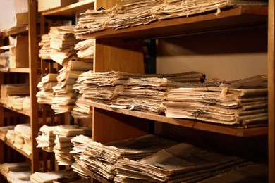 Image of Collection of old newspapers on shelves in library