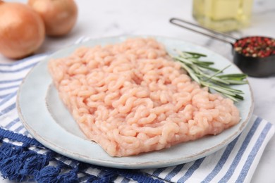 Photo of Fresh raw minced meat with rosemary on table, closeup