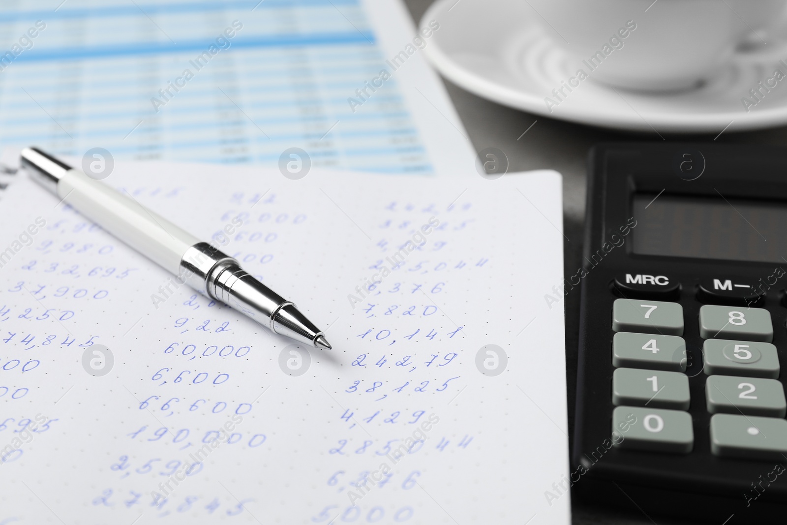 Photo of Calculator, pen and documents on table, closeup