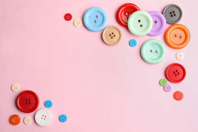 Photo of Many sewing buttons on pink background, flat lay. Space for text