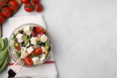 Tasty salad with tofu and vegetables served on light grey table, flat lay. Space for text