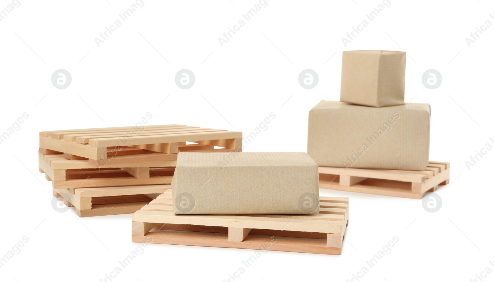 Photo of Small wooden pallets and boxes on white background