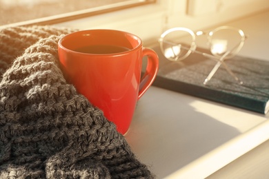 Composition with cup of winter drink on windowsill. Space for text