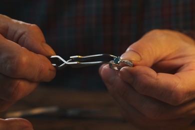 Professional jeweler working with ring, closeup view