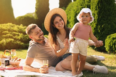 Happy family having picnic in garden on sunny day