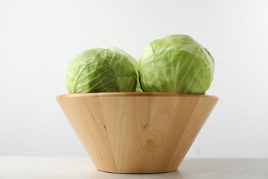 Photo of Ripe white cabbage on light marble table