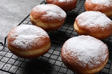 Delicious sweet buns with powdered sugar on table, closeup